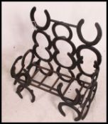 A vintage 20th century fire grate - fire box for a garden converted from horseshoes and painted.