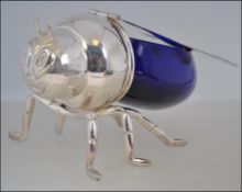 A silver plated and blue glass novelty honey pot in the form of a bee in the Mappin and Webb style