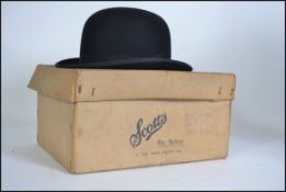 An early 20th century bowler hat size 6 7/8 by Scotts of Picadilly complete in original box