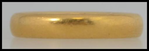 A 22ct hallmarked band ring size K, assay stamp for Birmingham with a total weight of 5.