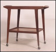 A retro Danish inspired teak wood serving trolley having two tiers raised on tapered legs on