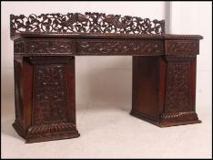 A 19th century Regency twin pedestal oak sideboard / desk the two single cupboards below a run of