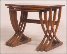 A retro teak wood nest of three Nathan teak tables,