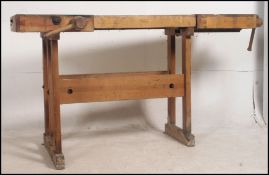 A 1970's wooden work bench by Linbergs of Sweden having an integrated adjustable vice and raised on