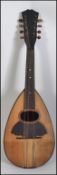 A vintage early 20th century Mandolin - musical instrument being strung with decorative satinwood