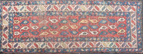 A Caucasian Kazak runner - rug having a central field with rows of Botehs, a ground of red,