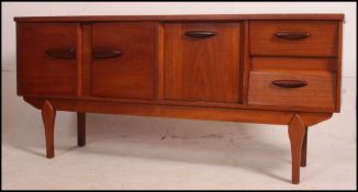 A Danish influence teak wood sideboard with angular drawers in the manner of Beautility.