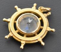 Gold ships wheel / helm , stamped 18ct to bail and tested as such , including main body .
