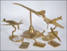 A collection of apprentice piece aircraft in brass to include Concorde x four and Spitfire's x two,
