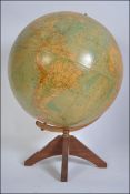 A retro desk globe. The parent Pupil Worldmaster Globe raised on a teak base.