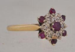 A good 18ct gold ruby and diamond cluster ring, the diamonds approx 8-10 pnts with ruby surround.
