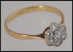 An 18ct gold and diamond ring having cluster flower head, the diamonds approx 25pnts. Weight 2.