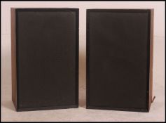 A pair of vintage / retro teak cased speakers with fabric covers and wall brackets attached