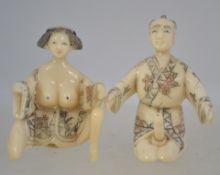 A 20th century Japanese bone carvings of an erotic couple character marks to base