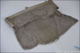 A large silver white metal ladies mesh purse with finial clasp and chain handle,