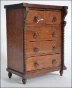 A 20th century Apprentice piece Scottish mahogany chest of drawers raised on turned legs with short