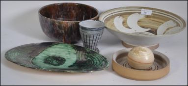 A good selection of studio pottery by various different makers to include bowls, vase,