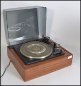 A retro Garrard four speed teak cased record deck with a smoked plastic cover