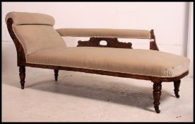 An Edwardian mahogany chaise longue - day bed being raised on turned legs with castors having