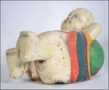 A large wooden carving of a reclining Buddha with painted body L37cm