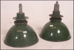 A pair of large vintage industrial factory enamel ceiling lights,