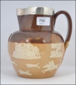 A silver hallmarked collared Harvest jug by Doulton Lambeth having impressed marks to the base.