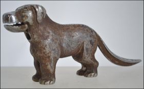 An early 20th century cast metal nutcracker in the form of a dog,