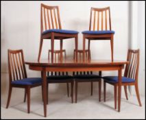 A good G-Plan 1970's teak dining table together with a set of 6 matching railed back dining chairs
