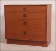 A 1970's G-Plan teak wood chest of drawers with inset plinth having an upright bank of drawers .