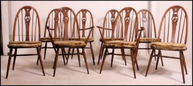 A set of eight Ercol elm seat and beech wheelback chairs,