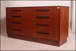 A G-Plan 1970's Fresco double teak wood chest of drawers raised on a plinth base with recessed