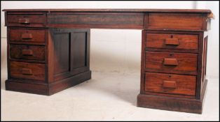 A 1920's large Air MInistry type desk raised on plinth bases with drawers above.