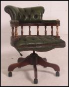 A 20th century green Leather Chesterfield deep button back swivel mahogany framed office chair