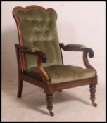 A Victorian / Regency mahogany armchair being raised on turned legs with shaped elbow rests.