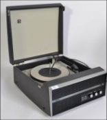 A vintage Bush mid century portable record player set within vinyl case having hinged top with