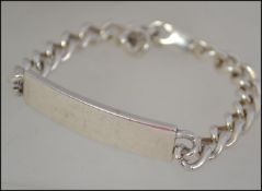 A silver hallmarked identity bracelet having a curb link chain along with a silver rope twist