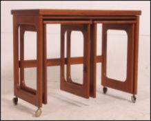 A 1970's McIntosh style teak wood nest of tables to include sliding tables to the underside 67cm