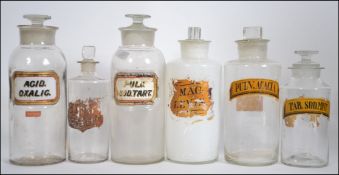 A good group of 19th Century chemist / apothecary glass bottles retaining original labels.