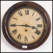 A Victorian station clock in mahogany being of circular form with large face and inset movement (