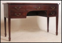 A Georgian style mahogany writing table desk having bow front top over a selection of drawers