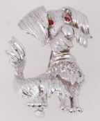 A vintage silver brooch of a scruffy dog