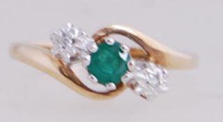 A 9ct gold diamond and green stone trilo