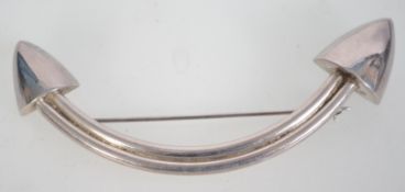 A large silver contemporry brooch with a