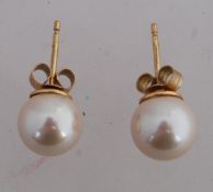 A pair of 9ct gold and pearl earrings. M