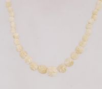 A vintage carved celluloid bead necklace