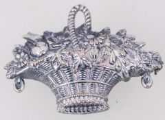 A vintage silver plated brooch of a flow