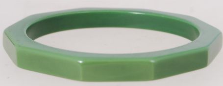 A vintage green Bakelite bangle with edg