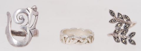 Three silver rings. One is a silver & ma
