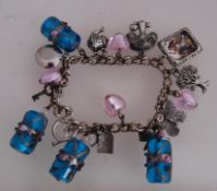 A contempry glass and white metal charm