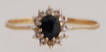 A 9ct gold sapphire and CZ cluster ring.